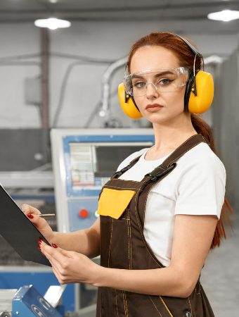 female-mechanic-in-uniform-and-protective-headphon-VMC4CGF.jpg