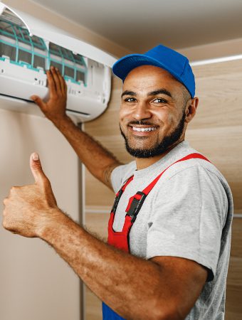 professional-repairman-installing-air-conditioner-HLXERZ5.jpg